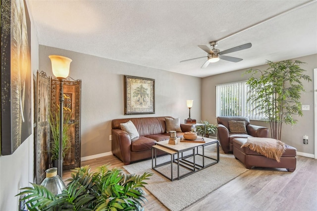 8080 112th St Unit 108, Seminole, FL 33772 - living room with wood finished floors, a textured ceiling, and a ceiling fan