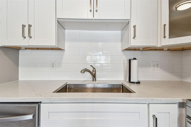 8080 112th St Unit 108, Seminole, FL 33772 - kitchen featuring white cabinetry, decorative backsplash, and dishwasher