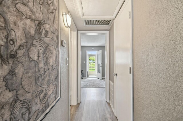 8080 112th St Unit 108, Seminole, FL 33772 - hallway featuring wood finished floors and a textured wall