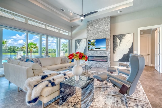 12902 SW 138th Loop, Dunnellon, FL 34432 - living room with crown molding, a towering ceiling, recessed lighting, a ceiling fan, and a stone fireplace