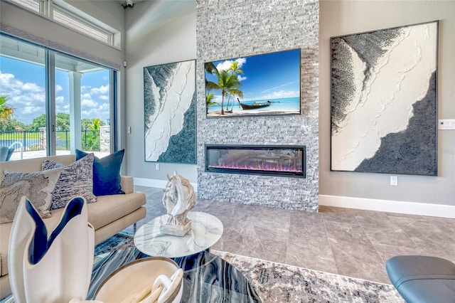 12902 SW 138th Loop, Dunnellon, FL 34432 - living room featuring baseboards and a stone fireplace