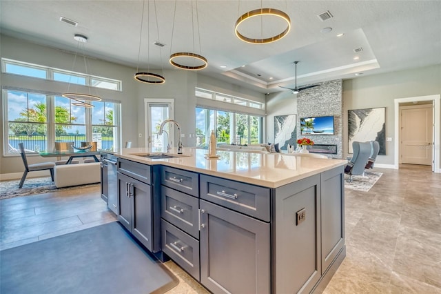 12902 SW 138th Loop, Dunnellon, FL 34432 - kitchen featuring open floor plan, a tray ceiling, gray cabinets, plenty of natural light, and recessed lighting