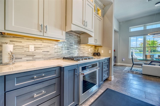 12902 SW 138th Loop, Dunnellon, FL 34432 - kitchen with appliances with stainless steel finishes, light stone counters, tasteful backsplash, and white cabinetry