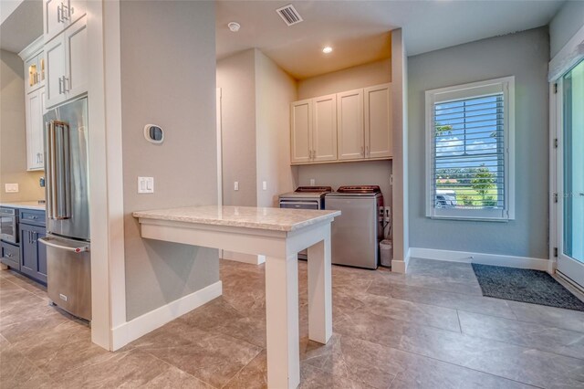 12902 SW 138th Loop, Dunnellon, FL 34432 - kitchen featuring high end fridge, washing machine and dryer, white cabinetry, recessed lighting, and light tile patterned floors