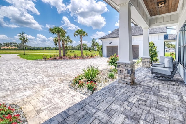 12902 SW 138th Loop, Dunnellon, FL 34432 - view of patio / terrace featuring decorative driveway and a garage