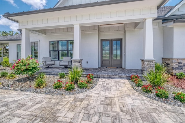 12902 SW 138th Loop, Dunnellon, FL 34432 - entrance to property featuring covered porch, stucco siding, french doors, and stone siding