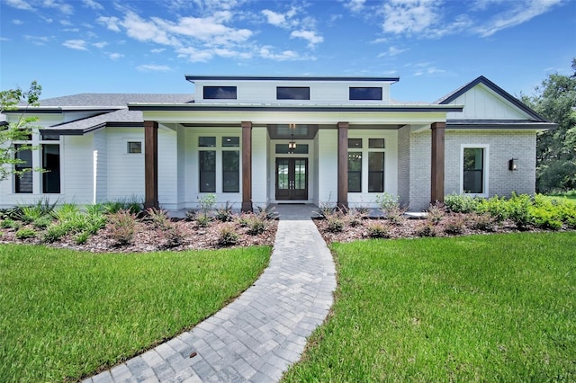 937 Old Welcome Rd, Lithia, FL 33547 - view of front of house with a porch, a front yard, and french doors