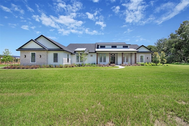 937 Old Welcome Rd, Lithia, FL 33547 - view of front of property with a front yard and a metal roof