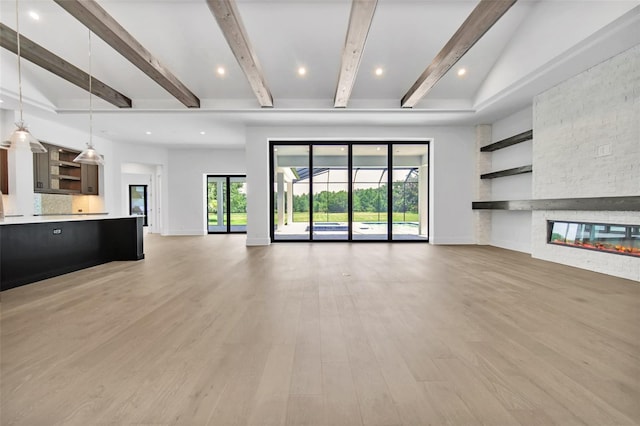 937 Old Welcome Rd, Lithia, FL 33547 - unfurnished living room featuring a fireplace, light wood-type flooring, beamed ceiling, and recessed lighting
