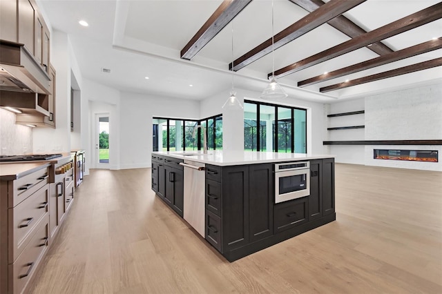937 Old Welcome Rd, Lithia, FL 33547 - kitchen with stainless steel appliances, light wood-type flooring, dark cabinets, light countertops, and recessed lighting