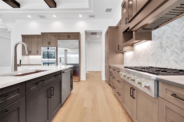 937 Old Welcome Rd, Lithia, FL 33547 - kitchen featuring appliances with stainless steel finishes, backsplash, light wood-style flooring, light countertops, and recessed lighting