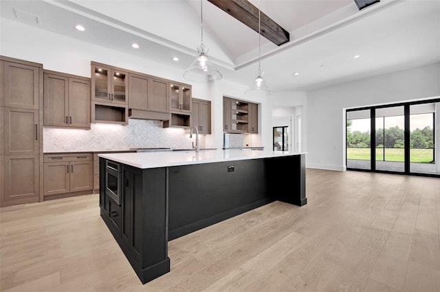 937 Old Welcome Rd, Lithia, FL 33547 - kitchen with recessed lighting, tasteful backsplash, a large island with sink, light countertops, and beamed ceiling