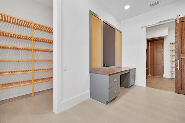 937 Old Welcome Rd, Lithia, FL 33547 - unfurnished bedroom with a barn door and recessed lighting