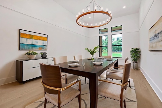 937 Old Welcome Rd, Lithia, FL 33547 - dining space with light wood finished floors, a chandelier, a towering ceiling, and recessed lighting