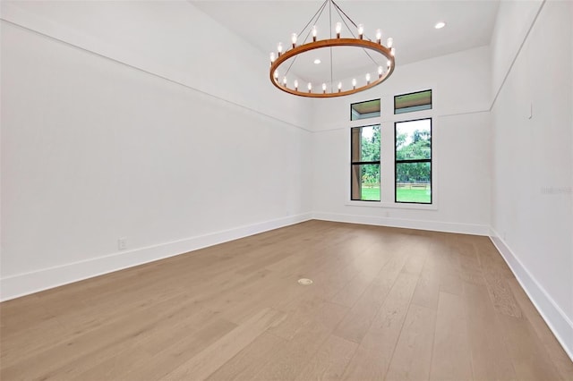 937 Old Welcome Rd, Lithia, FL 33547 - unfurnished room featuring a chandelier, wood finished floors, a towering ceiling, and recessed lighting