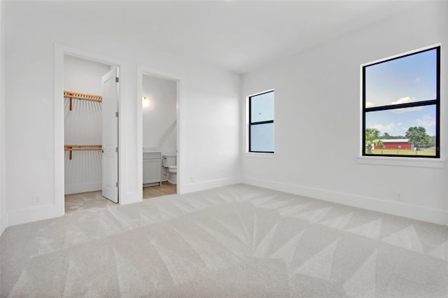 937 Old Welcome Rd, Lithia, FL 33547 - unfurnished bedroom featuring carpet floors, ensuite bathroom, and a walk in closet