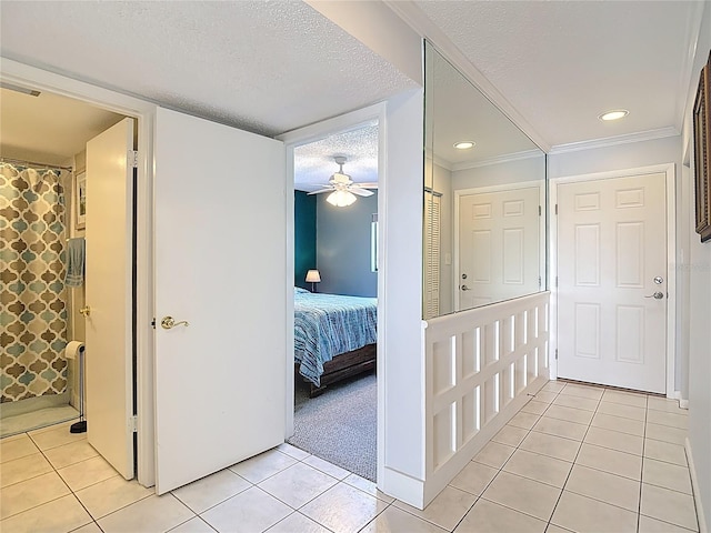 809 Bahia Del Sol Dr Unit 72, Ruskin, FL 33570 - corridor featuring light tile patterned flooring, a textured ceiling, ornamental molding, and recessed lighting