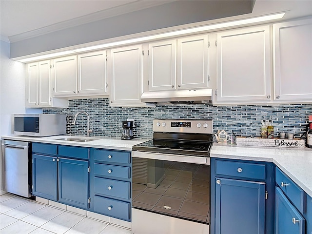 809 Bahia Del Sol Dr Unit 72, Ruskin, FL 33570 - kitchen with appliances with stainless steel finishes, blue cabinets, under cabinet range hood, light tile patterned floors, and crown molding