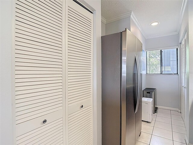809 Bahia Del Sol Dr Unit 72, Ruskin, FL 33570 - kitchen with freestanding refrigerator, ornamental molding, light tile patterned flooring, and a textured ceiling