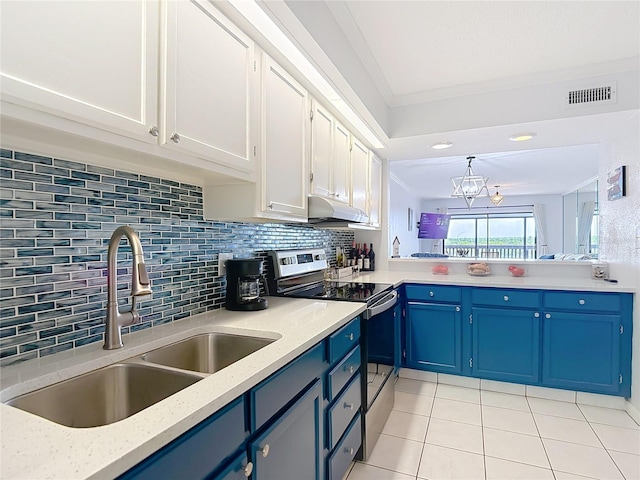 809 Bahia Del Sol Dr Unit 72, Ruskin, FL 33570 - kitchen with stainless steel range with electric cooktop, blue cabinets, under cabinet range hood, light tile patterned floors, and white cabinetry