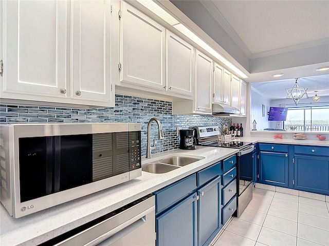 809 Bahia Del Sol Dr Unit 72, Ruskin, FL 33570 - kitchen featuring blue cabinetry, appliances with stainless steel finishes, light tile patterned floors, crown molding, and light countertops