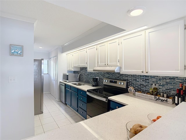 809 Bahia Del Sol Dr Unit 72, Ruskin, FL 33570 - kitchen with stainless steel appliances, under cabinet range hood, white cabinets, light tile patterned floors, and ornamental molding