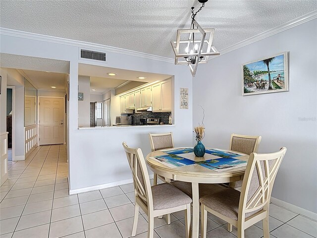 809 Bahia Del Sol Dr Unit 72, Ruskin, FL 33570 - dining room featuring light tile patterned floors, a chandelier, ornamental molding, and a textured ceiling