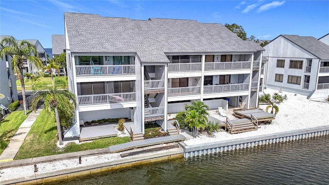 809 Bahia Del Sol Dr Unit 72, Ruskin, FL 33570 - rear view of property featuring roof with shingles, a water view, and stairway