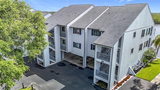 809 Bahia Del Sol Dr Unit 72, Ruskin, FL 33570 - back of house featuring roof with shingles, stairway, and a balcony
