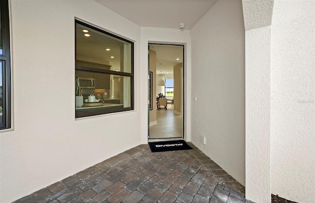 14317 Eagle Branch Dr, Nokomis, FL 34275 - property entrance with stucco siding and a surveillance system