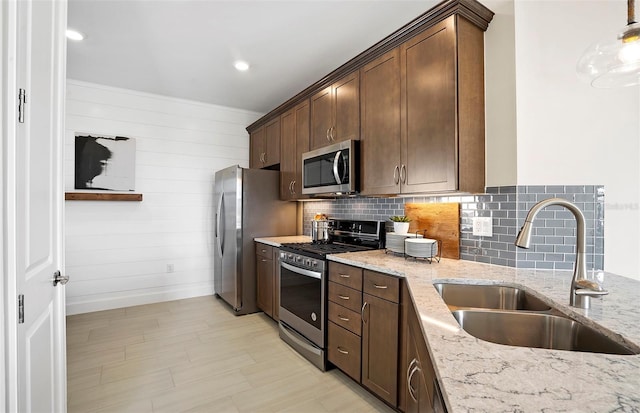 14317 Eagle Branch Dr, Nokomis, FL 34275 - kitchen featuring appliances with stainless steel finishes, light stone counters, backsplash, and dark brown cabinetry