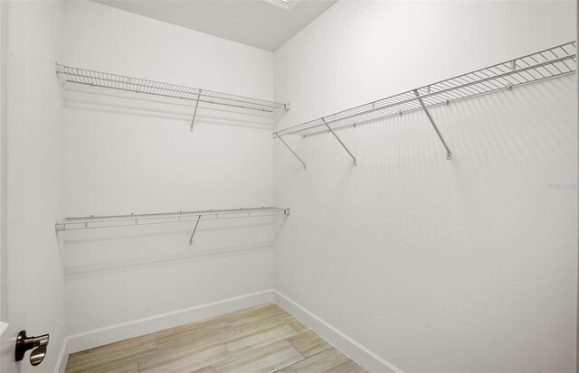 14317 Eagle Branch Dr, Nokomis, FL 34275 - walk in closet with light wood-style floors