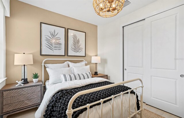 14317 Eagle Branch Dr, Nokomis, FL 34275 - bedroom with a chandelier and a closet