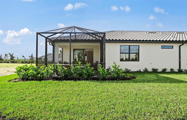 14317 Eagle Branch Dr, Nokomis, FL 34275 - rear view of property featuring a lawn, stucco siding, and glass enclosure