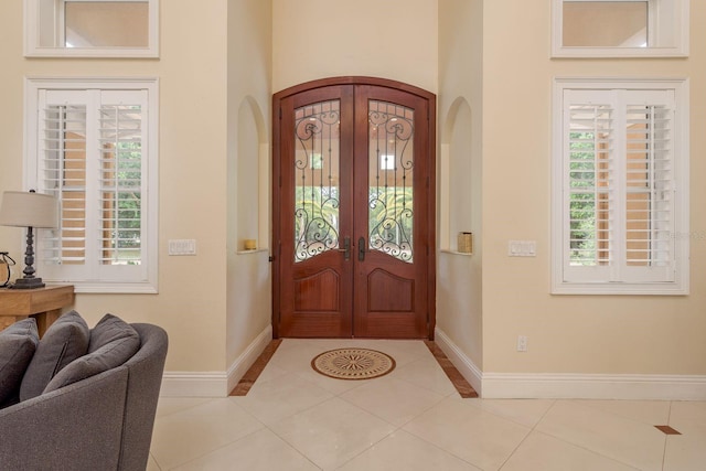 11430 Trotting Down Dr, Odessa, FL 33556 - entrance foyer with arched walkways, french doors, and light tile patterned floors