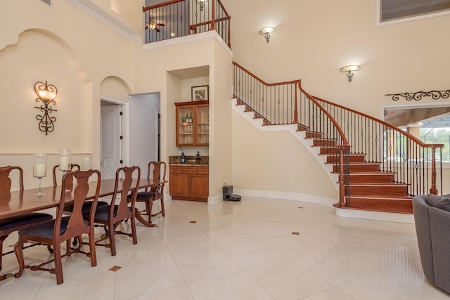 11430 Trotting Down Dr, Odessa, FL 33556 - dining space with a high ceiling, stairway, and light tile patterned flooring