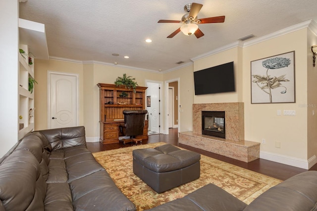 11430 Trotting Down Dr, Odessa, FL 33556 - living room with a ceiling fan, wood finished floors, a high end fireplace, a textured ceiling, and ornamental molding