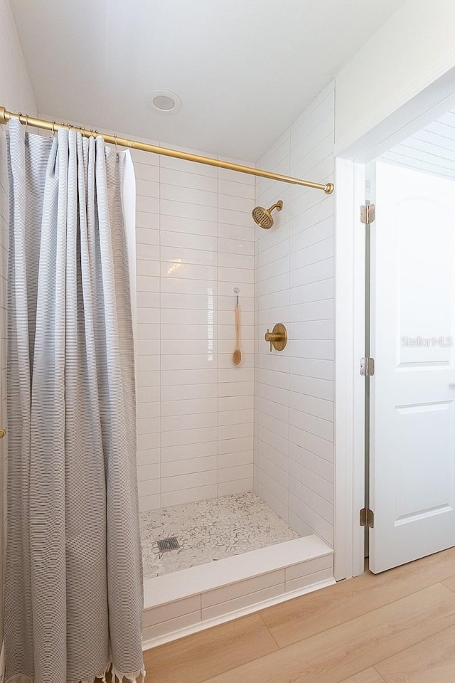 434 77th Ave, St Pete Beach, FL 33706 - bathroom with wood finished floors and tiled shower