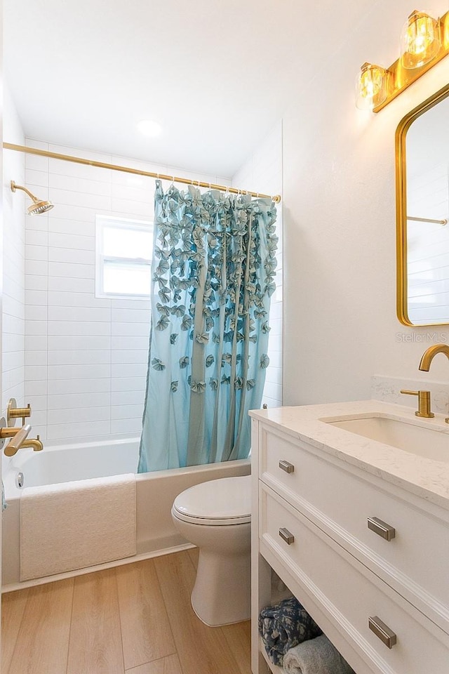 434 77th Ave, St Pete Beach, FL 33706 - bathroom with wood finished floors, shower / bathtub combination with curtain, and vanity