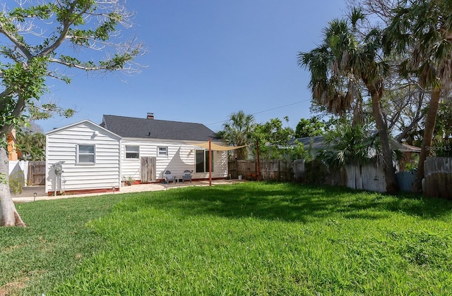 434 77th Ave, St Pete Beach, FL 33706 - rear view of property with a fenced backyard, a patio, and a chimney