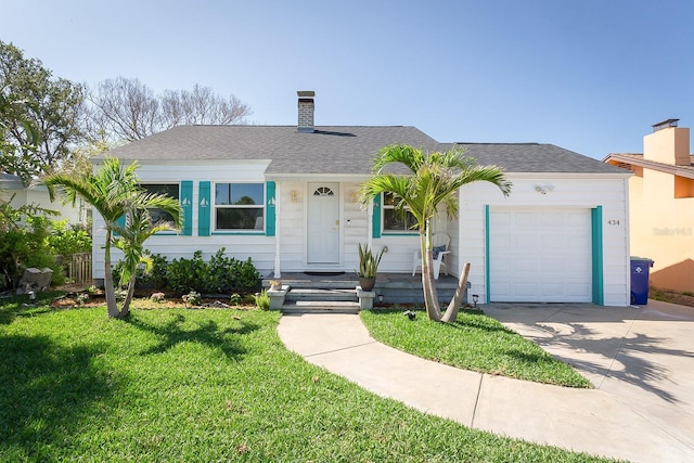 434 77th Ave, St Pete Beach, FL 33706 - view of front of property featuring a chimney, an attached garage, a front lawn, driveway, and a shingled roof