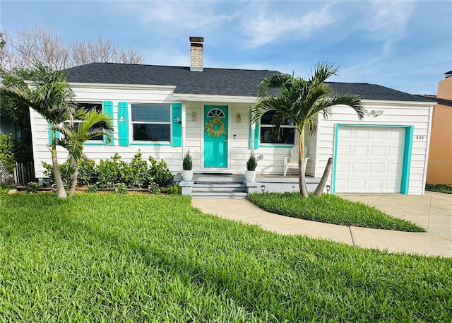 434 77th Ave, St Pete Beach, FL 33706 - view of front of home with a chimney, a front lawn, an attached garage, and a shingled roof
