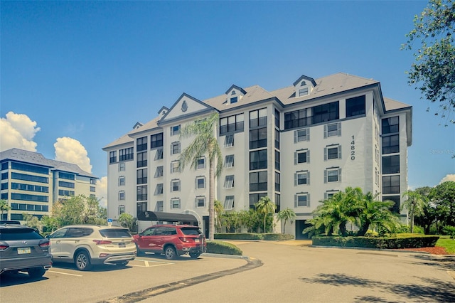 14820 Rue De Bayonne Unit 301, Clearwater, FL 33762 - view of apartment building / complex with uncovered parking