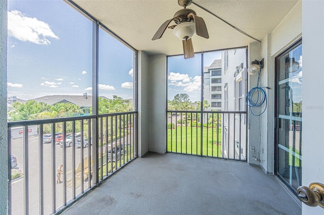 14820 Rue De Bayonne Unit 301, Clearwater, FL 33762 - unfurnished sunroom featuring ceiling fan