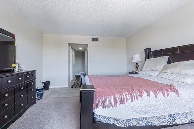 14820 Rue De Bayonne Unit 301, Clearwater, FL 33762 - carpeted bedroom featuring a textured ceiling and baseboards