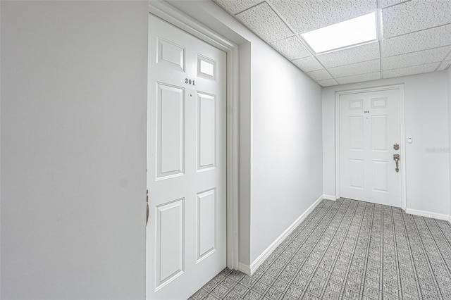 14820 Rue De Bayonne Unit 301, Clearwater, FL 33762 - hallway featuring carpet flooring and a paneled ceiling