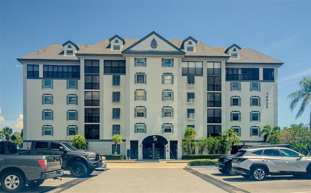 14820 Rue De Bayonne Unit 301, Clearwater, FL 33762 - view of building exterior with uncovered parking