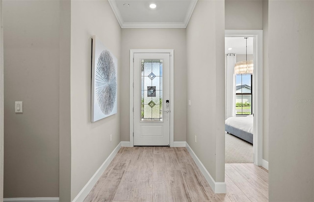 6162 Winding Pine Dr, Nokomis, FL 34275 - entryway featuring healthy amount of natural light, light wood finished floors, and crown molding