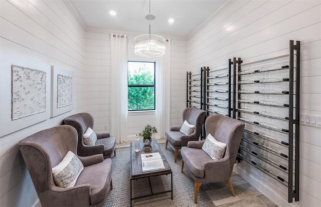 6162 Winding Pine Dr, Nokomis, FL 34275 - sitting room featuring a chandelier, ornamental molding, and wood walls