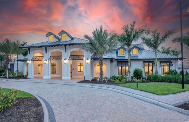 6162 Winding Pine Dr, Nokomis, FL 34275 - view of front of home with a standing seam roof, stucco siding, and a metal roof